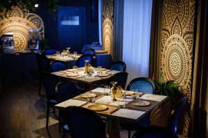 Restaurant interior design with gold plates and blue chairs